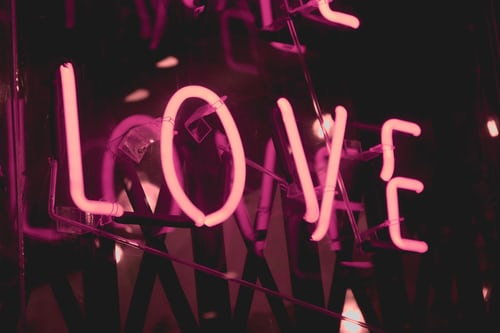 The word LOVE in a neon pink lighted sign.