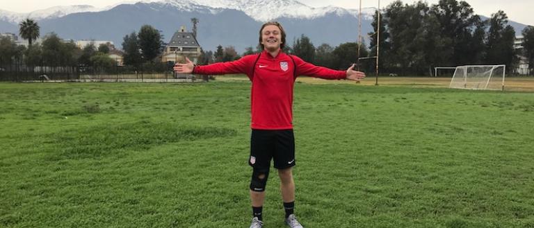Shea Hammond standing on a soccer field with arms open