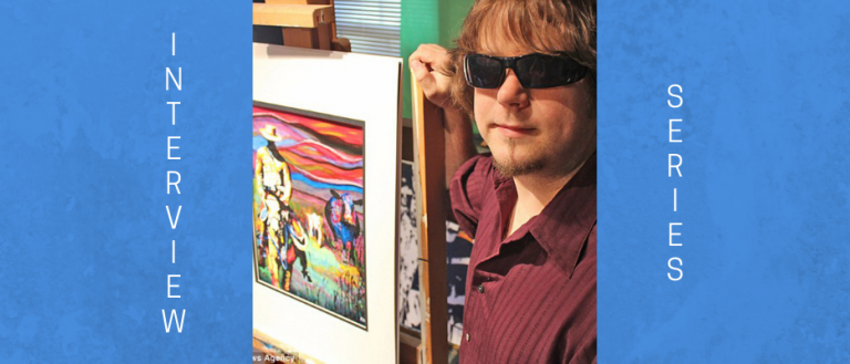 Image of man with black sunglasses. he has light brown shaggy hair and is wearing a maroon polo shirt unbuttoned. He is standing next to one of his paintings, which is on an easel in his workshop.