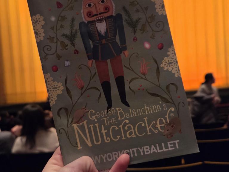Nutcracker program in front of the theater curtain 