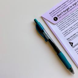 Image Description: Voter ballot and blue pen. 