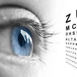 Blue eye looking closely at the Snellen Eye Chart