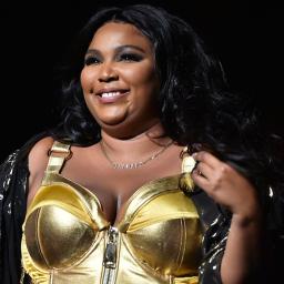 Image of Lizzo smiling at the camera. 