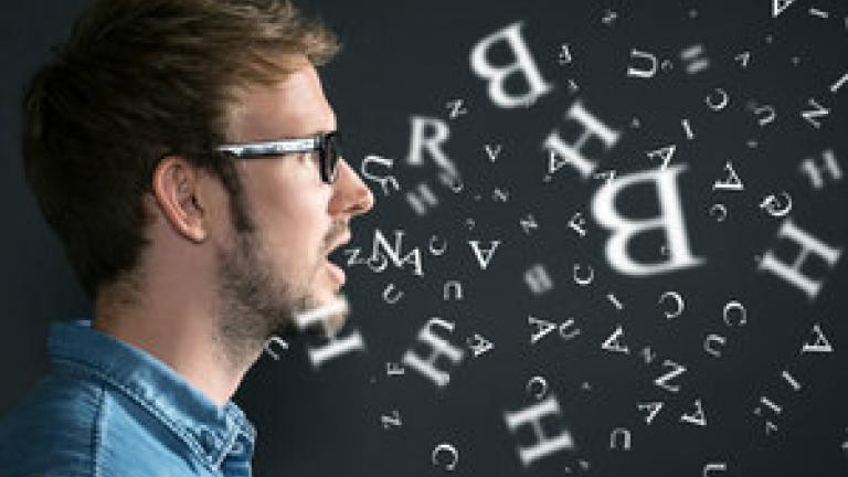 Image Description: A man is shown in profile with his mouth open. Many letters float in front of his mouth.