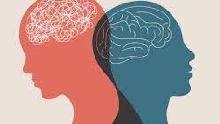 A sillouette of two people looknig in opposite directions