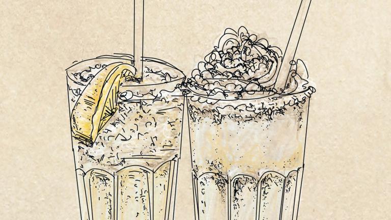 Two drinks one with a lemon and one with a whipped cream topping